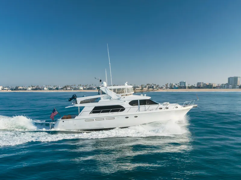 Slide: The Image of 2003 Ocean Alexander 64 Pilothouse yacht cruising on open water. - 13