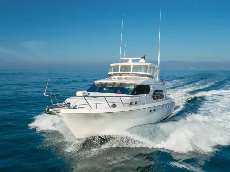 Slide: The Image of 2003 Ocean Alexander 64 Pilothouse yacht cruising on open water. - 14