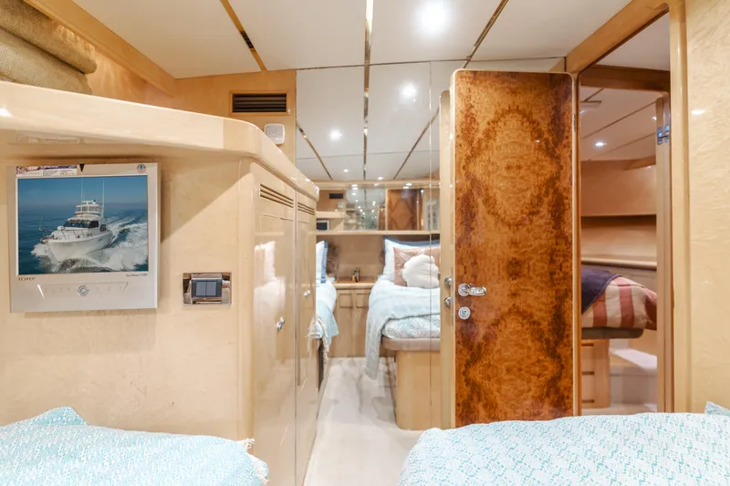 Slide: The Image of Luxurious interior of 2003 Ocean Alexander 64 Pilothouse yacht, featuring cozy twin beds and elegant wood finishes. - 24
