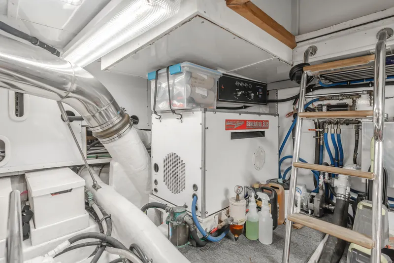 Slide: The Image of Engine room of 2003 Ocean Alexander 64 Pilothouse yacht, featuring equipment and storage. - 32