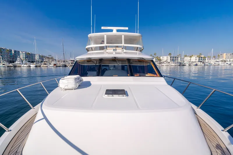 Slide: The Image of 2003 Ocean Alexander 64 Pilothouse yacht docked in a marina, clear blue sky. - 47
