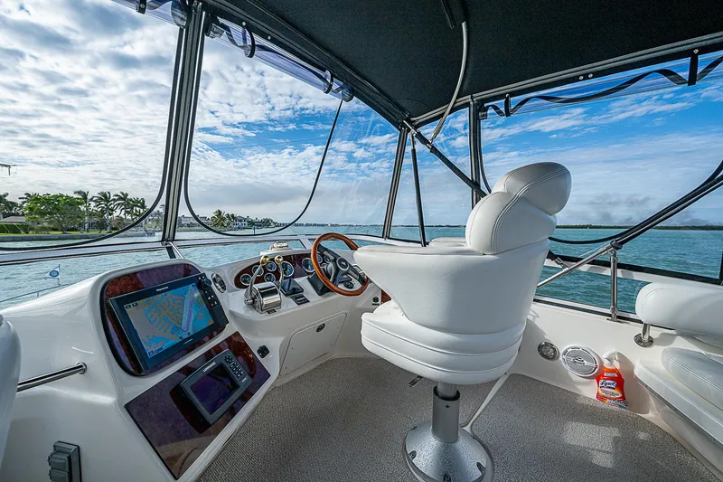 Slide: The Image of 2001 Sea Ray 400 Sedan Bridge helm with ocean view, featuring modern navigation equipment. - 10