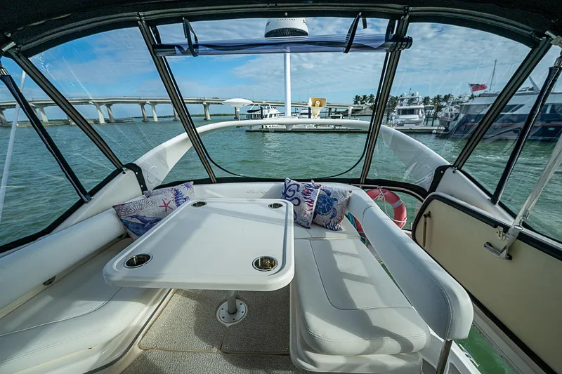 Slide: The Image of Interior view of 2001 Sea Ray 400 Sedan Bridge yacht with seating and table. - 12