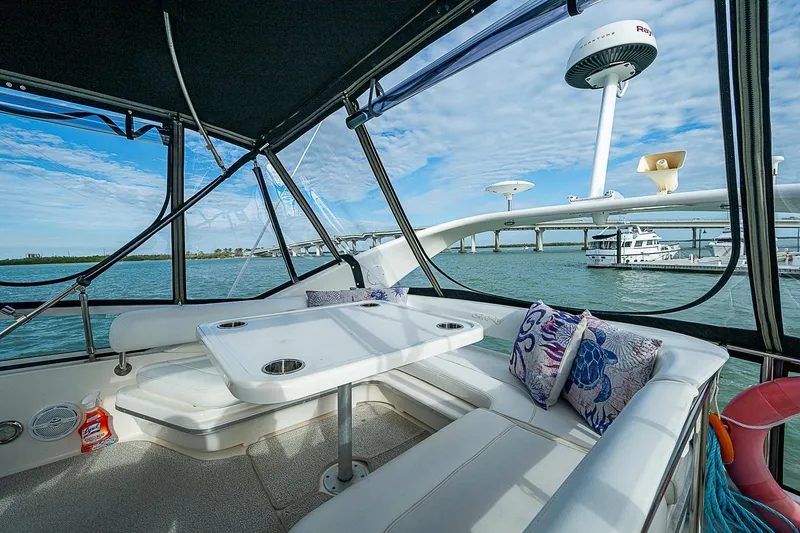 Slide: The Image of Interior view of 2001 Sea Ray 400 Sedan Bridge yacht with seating and table. - 13