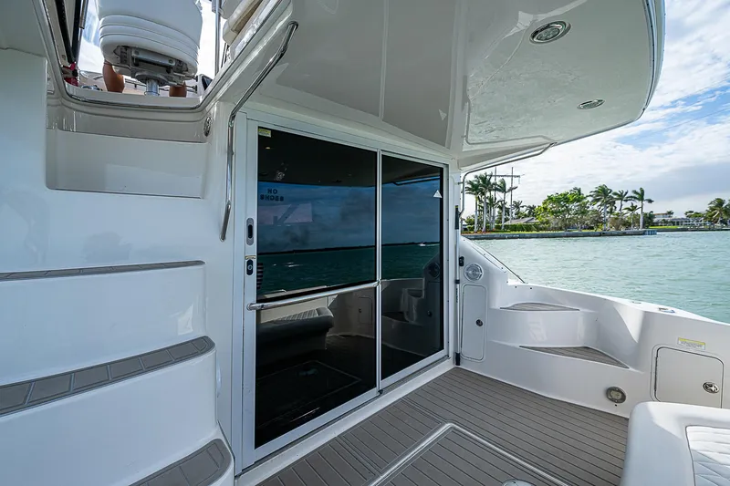 Slide: The Image of 2001 Sea Ray 400 Sedan Bridge yacht, rear deck view with sliding glass doors. - 15