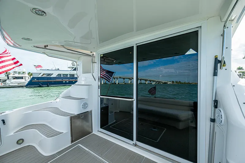 Slide: The Image of 2001 Sea Ray 400 Sedan Bridge yacht with sleek design and waterfront view. - 16