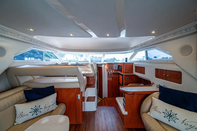 Slide: The Image of Interior of 2001 Sea Ray 400 Sedan Bridge yacht, featuring luxurious seating and wood finishes. - 17
