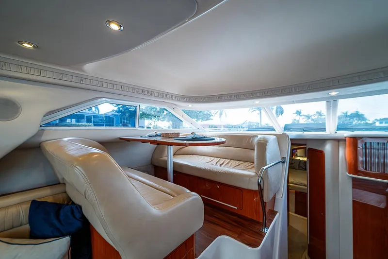 Slide: The Image of Interior of 2001 Sea Ray 400 Sedan Bridge yacht with plush seating and dining area. - 18
