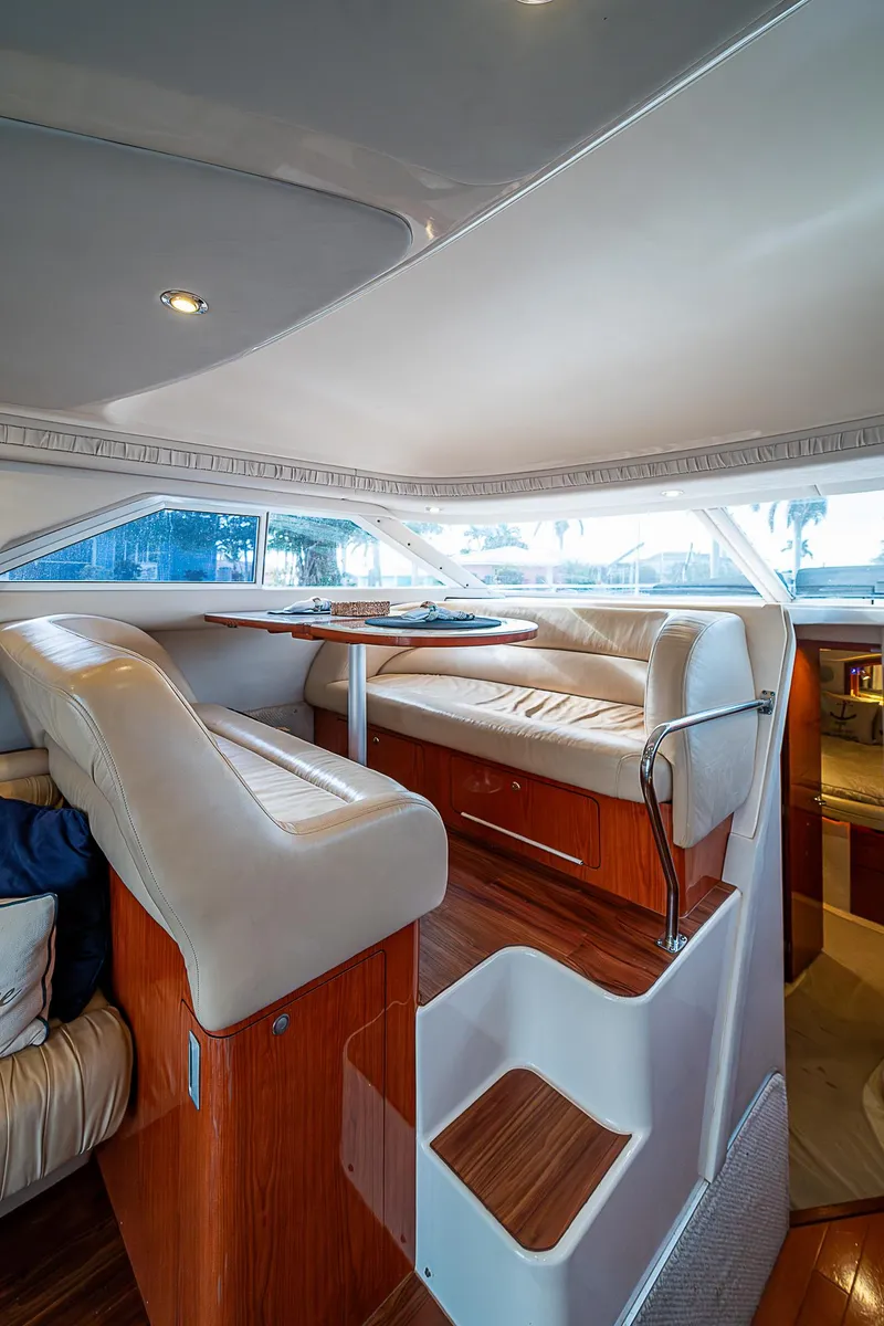 Slide: The Image of Interior of 2001 Sea Ray 400 Sedan Bridge yacht with plush seating and wooden accents. - 19