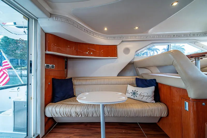 Slide: The Image of Interior of 2001 Sea Ray 400 Sedan Bridge yacht with cozy seating and table. - 20