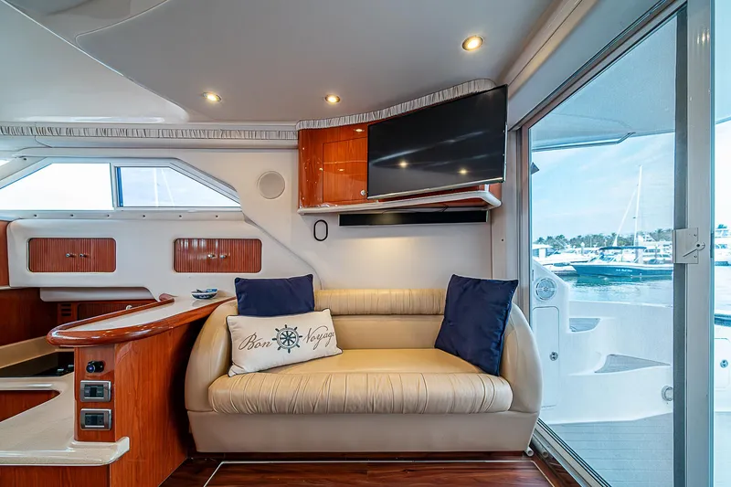 Slide: The Image of Interior of 2001 Sea Ray 400 Sedan Bridge yacht with sofa and TV. - 21