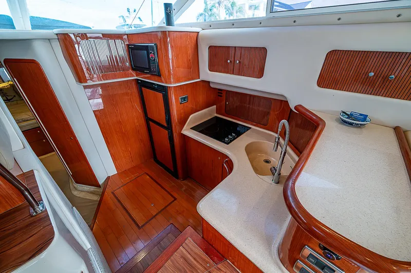 Slide: The Image of Interior of 2001 Sea Ray 400 Sedan Bridge yacht with modern kitchen amenities. - 29