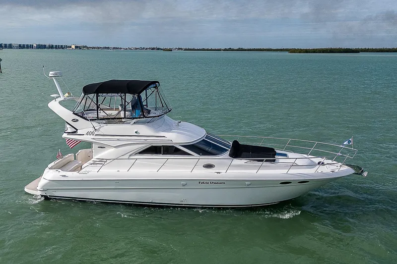 Slide: The Image of 2001 Sea Ray 400 Sedan Bridge yacht cruising on calm waters. - 3