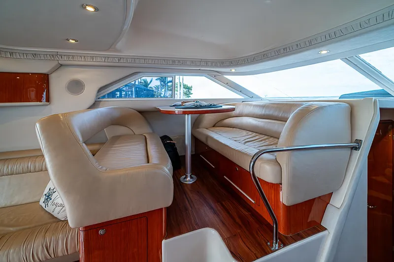 Slide: The Image of Interior of 2001 Sea Ray 400 Sedan Bridge with plush seating and wooden accents. - 31