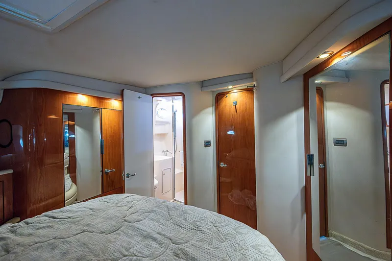 Slide: The Image of Interior of 2001 Sea Ray 400 Sedan Bridge, featuring wood paneling and cozy bedroom. - 35