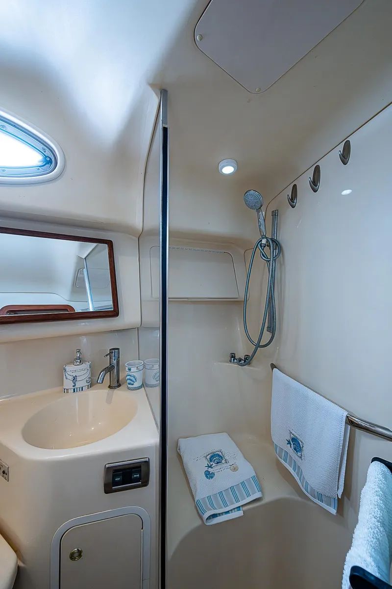 Slide: The Image of 2001 Sea Ray 400 Sedan Bridge bathroom with sink, mirror, and shower. - 37