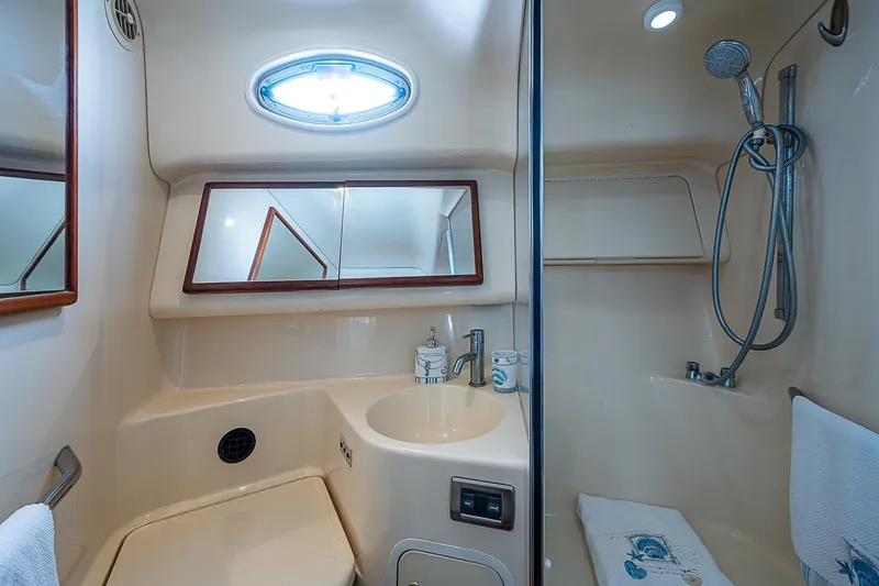 Slide: The Image of 2001 Sea Ray 400 Sedan Bridge bathroom with shower, sink, and mirror. - 38