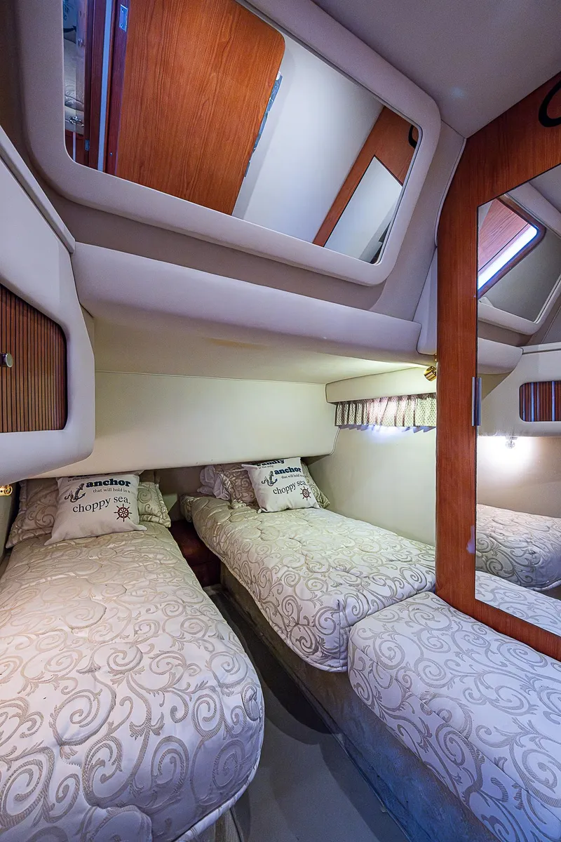 Slide: The Image of Interior cabin of 2001 Sea Ray 400 Sedan Bridge with twin beds and elegant decor. - 40