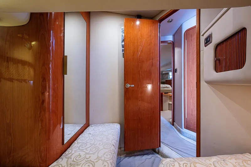 Slide: The Image of Interior of 2001 Sea Ray 400 Sedan Bridge, featuring wood paneling and cozy cabin space. - 42