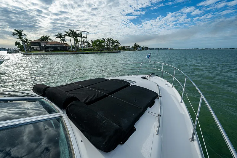 Slide: The Image of 2001 Sea Ray 400 Sedan Bridge cruising on a scenic waterway with palm trees and cloudy sky. - 44