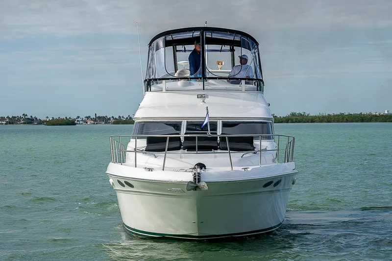 Slide: The Image of 2001 Sea Ray 400 Sedan Bridge yacht on calm water, front view. - 48
