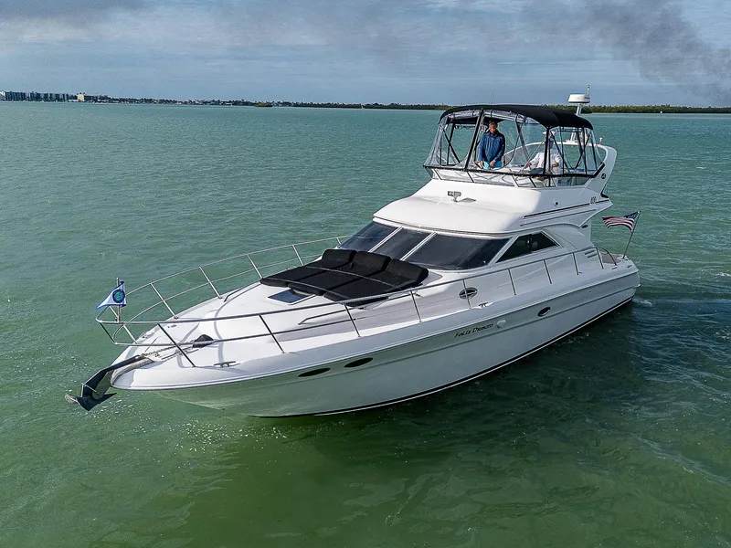 Slide: The Image of 2001 Sea Ray 400 Sedan Bridge yacht cruising on calm waters. - 5