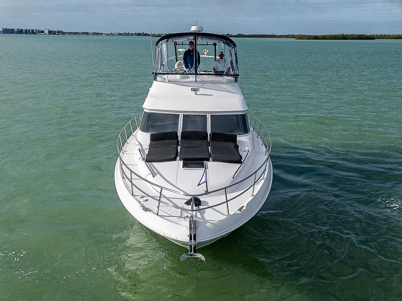 Slide: The Image of 2001 Sea Ray 400 Sedan Bridge yacht cruising on calm waters. - 6