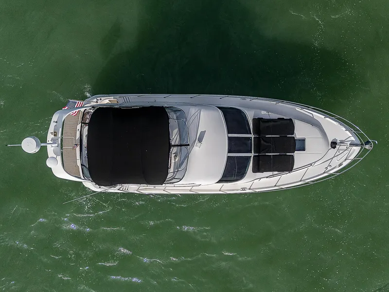 Slide: The Image of Top view of 2001 Sea Ray 400 Sedan Bridge yacht on green water. - 7