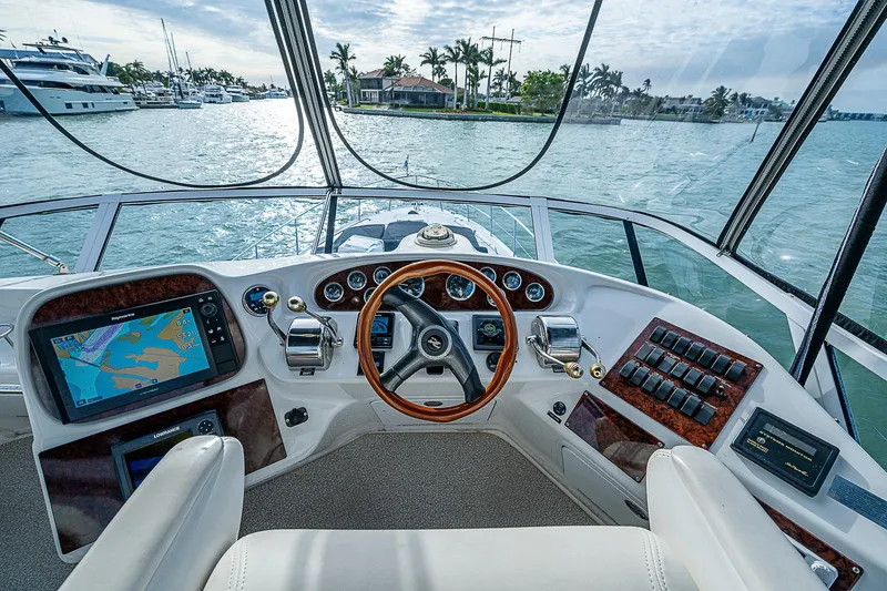 Slide: The Image of Cockpit view of 2001 Sea Ray 400 Sedan Bridge yacht with navigation equipment. - 8