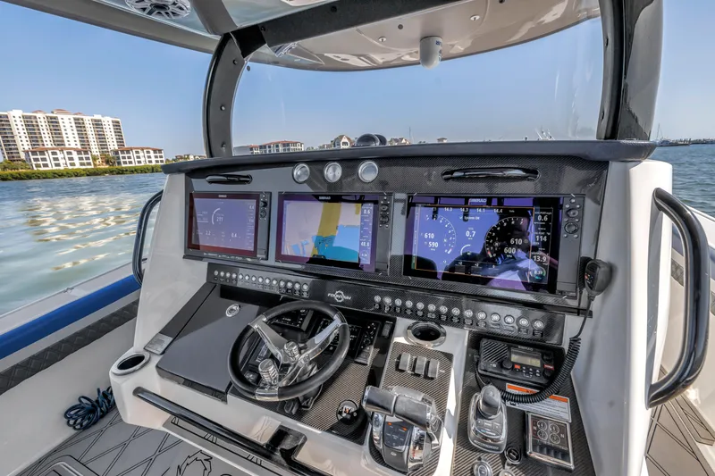 Slide: The Image of 2019 Fountain 43NX boat dashboard with advanced navigation displays and controls. - 15