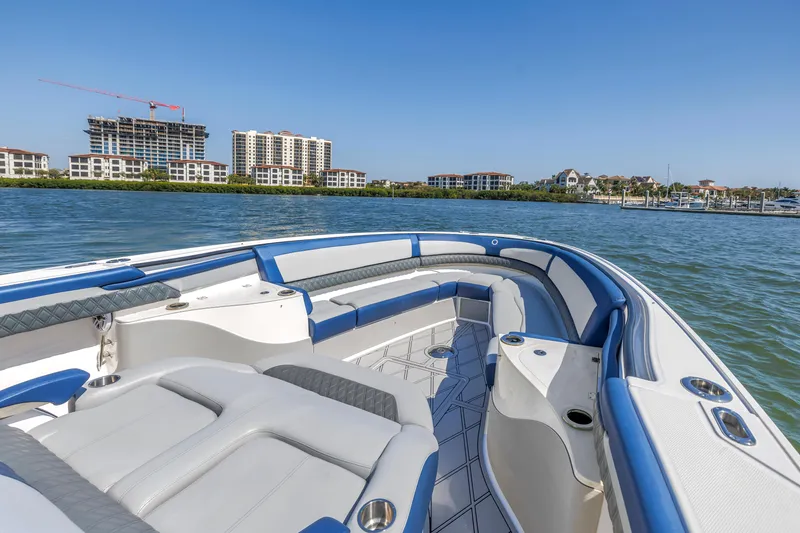 Slide: The Image of 2019 Fountain 43NX boat with spacious seating, cruising on a sunny waterfront. - 17