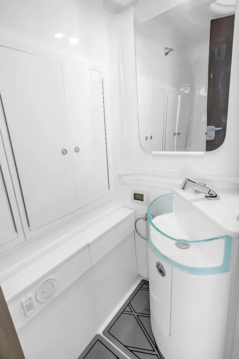 Slide: The Image of Modern bathroom interior on 2019 Fountain 43NX boat, featuring sleek design and compact fixtures. - 22