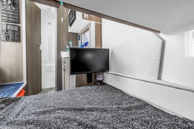 Slide: The Image of Interior of 2019 Fountain 43NX boat with bed, TV, and kitchenette. - 23