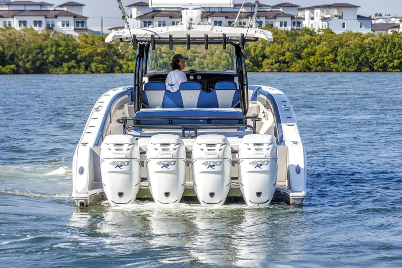 Slide: The Image of 2019 Fountain 43NX boat with four powerful engines cruising on water. - 8