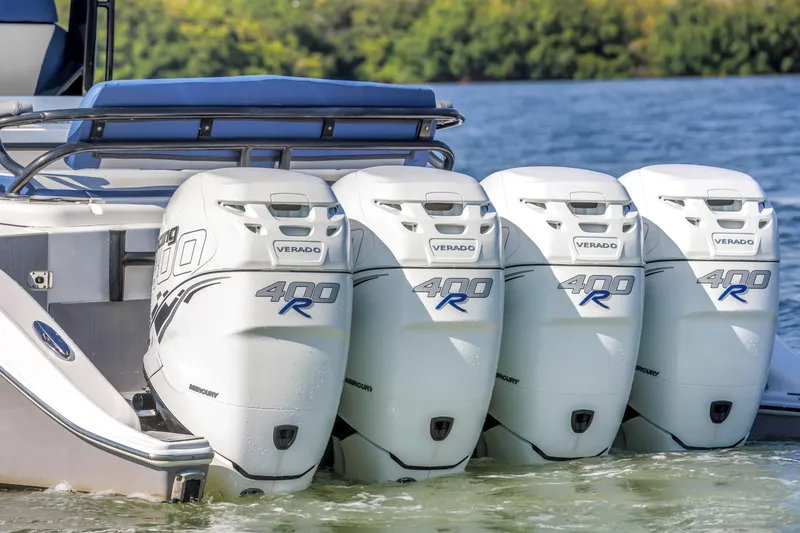 Slide: The Image of Four powerful outboard motors on a 2019 Fountain 43NX boat, cruising on water. - 9