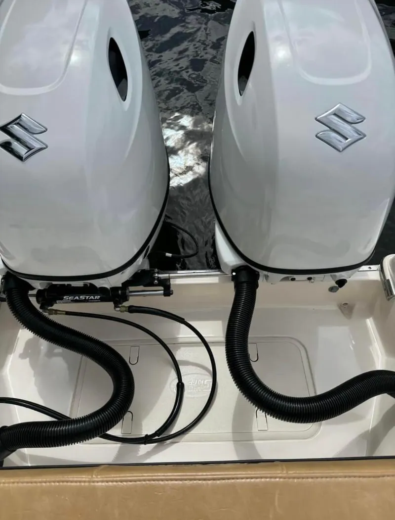 Slide: The Image of 2024 Sea Chaser 24 HFC boat with dual Suzuki outboard motors. - 10