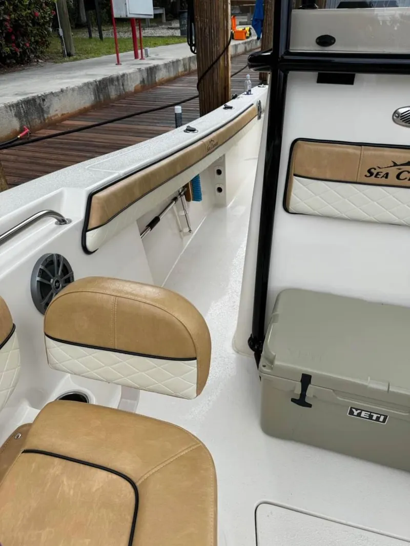 Slide: The Image of 2024 Sea Chaser 24 HFC boat interior with tan seating and Yeti cooler. - 12