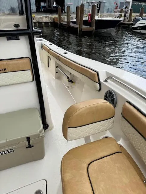 Slide: The Image of 2024 Sea Chaser 24 HFC boat interior with tan seating and Yeti cooler. - 13