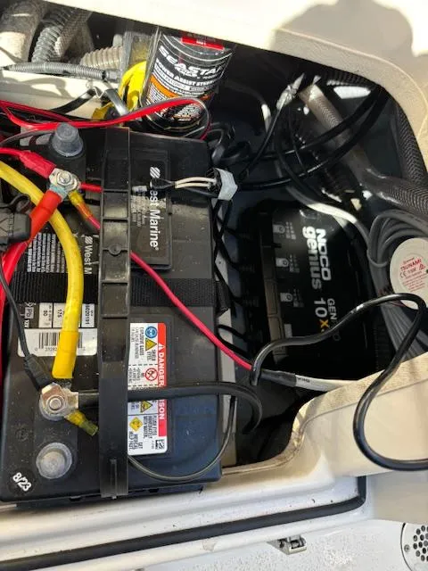 Slide: The Image of 2024 Sea Chaser 24 HFC boat battery compartment with wiring and charger. - 15