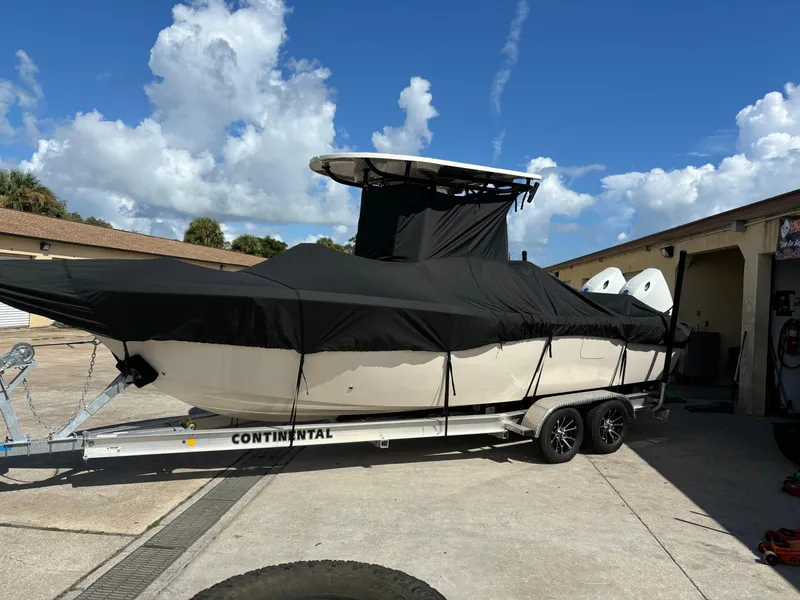 Slide: The Image of 2024 Sea Chaser 24 HFC boat on trailer, covered, parked outdoors. - 19