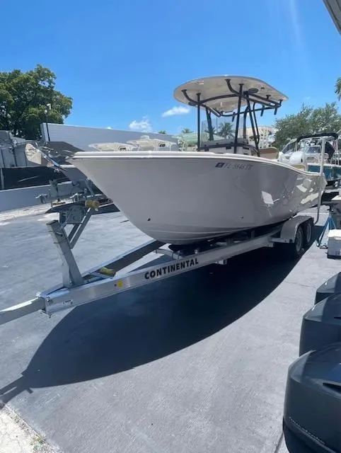 Slide: The Image of 2024 Sea Chaser 24 HFC boat on trailer, parked outdoors. - 2