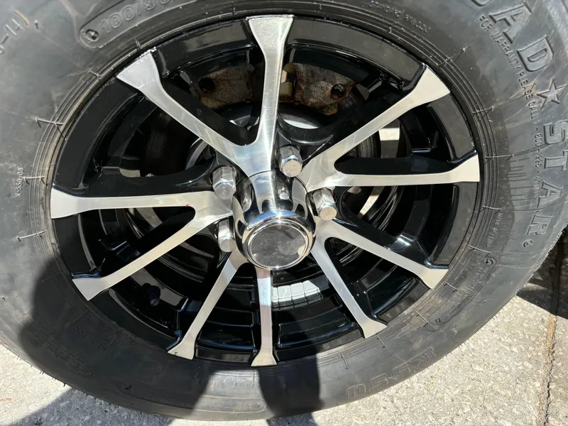 Slide: The Image of Chrome and black alloy wheel of 2024 Sea Chaser 24 HFC boat trailer. - 20