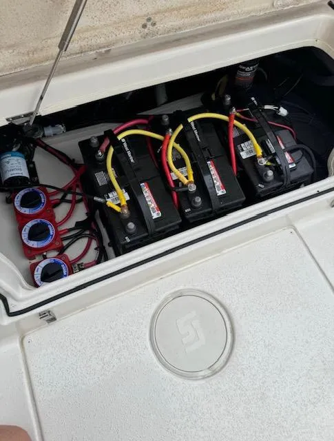 Slide: The Image of 2024 Sea Chaser 24 HFC boat battery compartment with wiring and connections. - 31