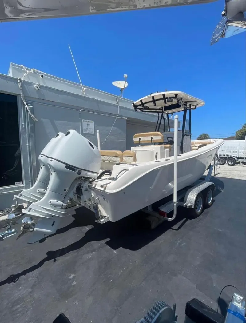 Slide: The Image of 2024 Sea Chaser 24 HFC boat on trailer, featuring a powerful outboard motor. - 5