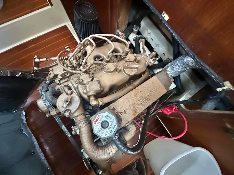 Slide: The Image of 1986 Catalina 36 engine compartment with visible mechanical components and wiring. - 11