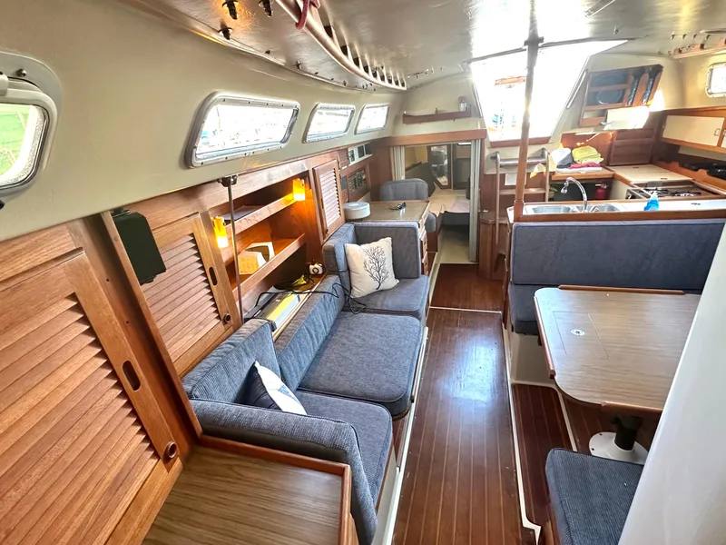 Slide: The Image of Interior of 1986 Catalina 36 sailboat with cozy seating and wooden accents. - 12