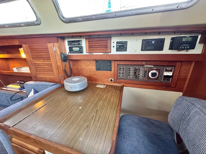 Slide: The Image of Interior of a 1986 Catalina 36 sailboat with navigation equipment and wooden table. - 19