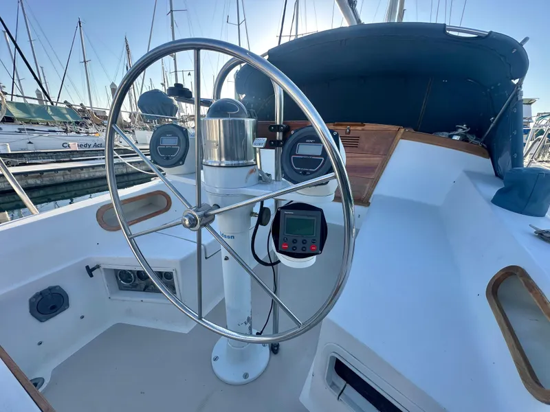 Slide: The Image of Steering wheel of a 1986 Catalina 36 sailboat in a marina setting. - 25