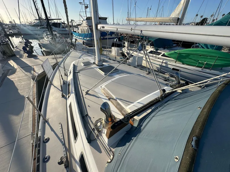 Slide: The Image of 1986 Catalina 36 sailboat docked in marina, showing deck and rigging details. - 7