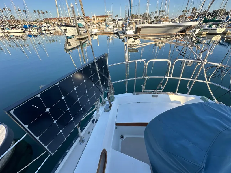 Slide: The Image of 1986 Catalina 36 sailboat with solar panel in marina setting. - 9